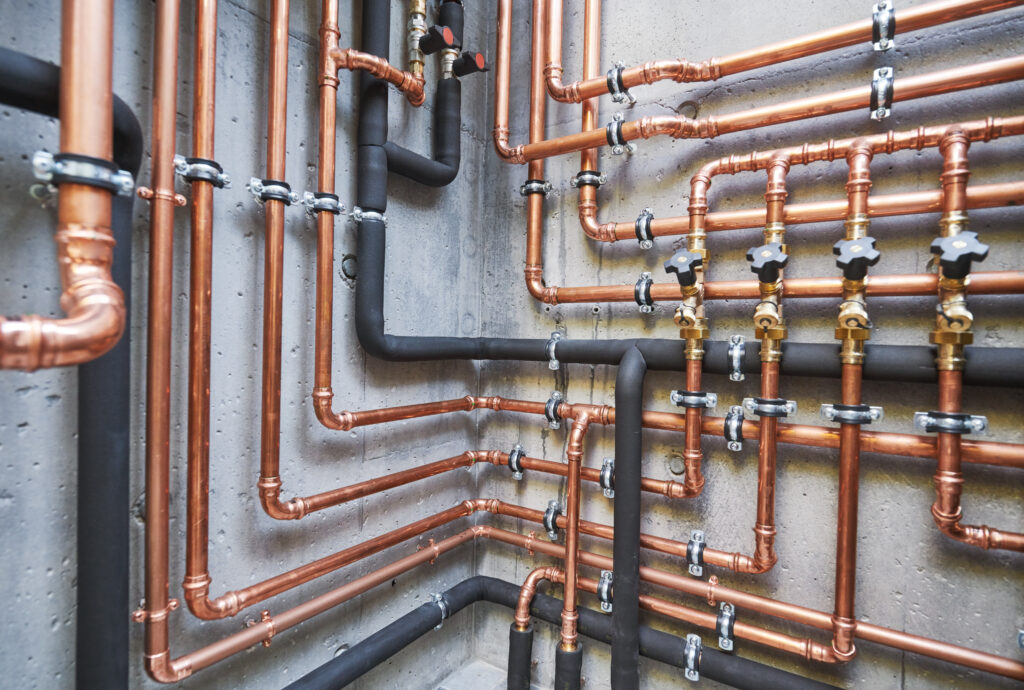 a wall of pipes and piping in a building