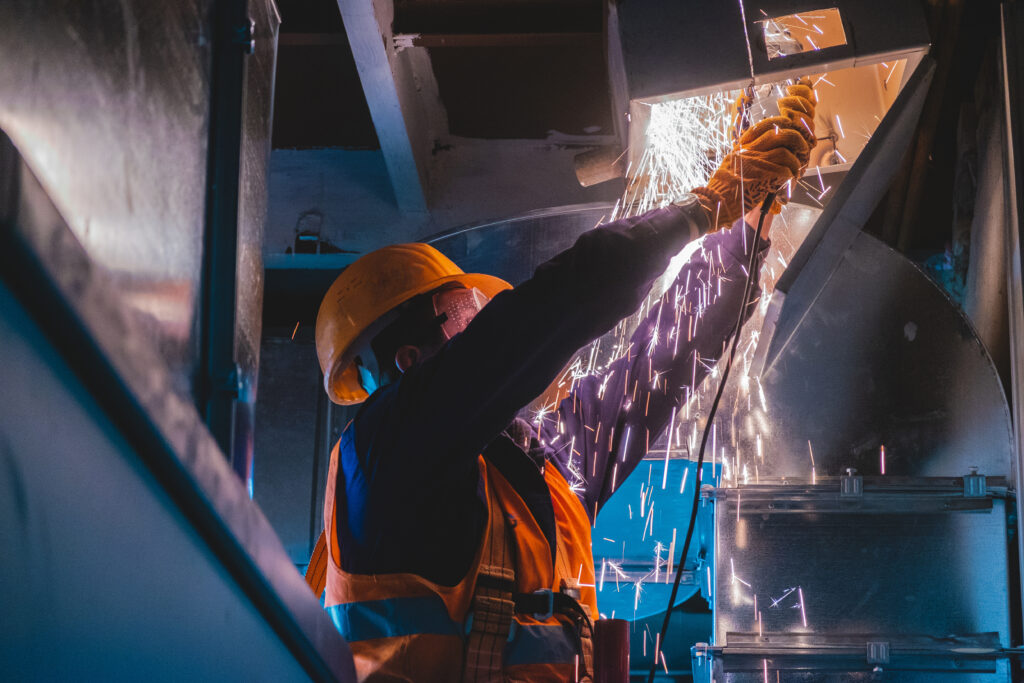 a man working on a machine in a factory